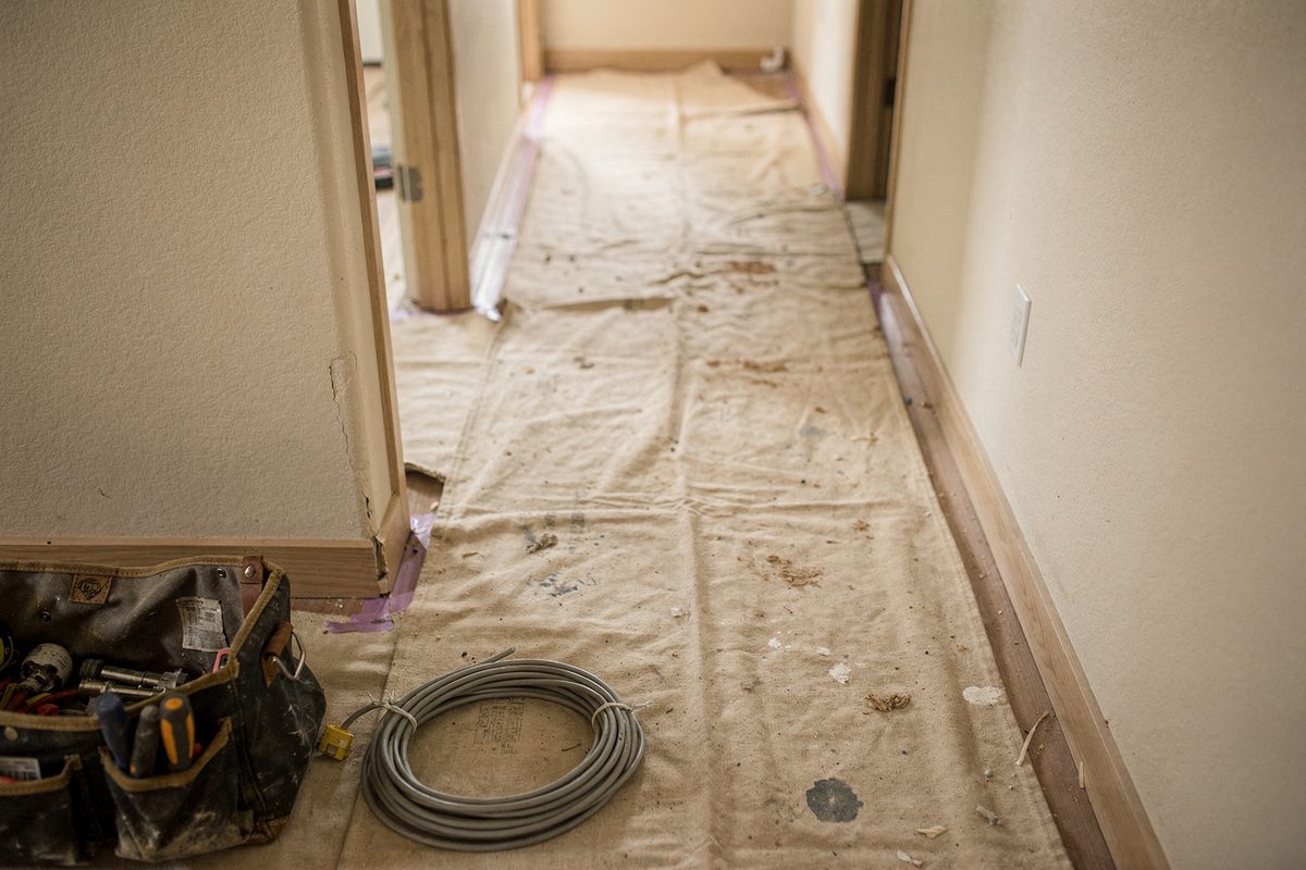 Drop cloths and floor protection laid out before work begins